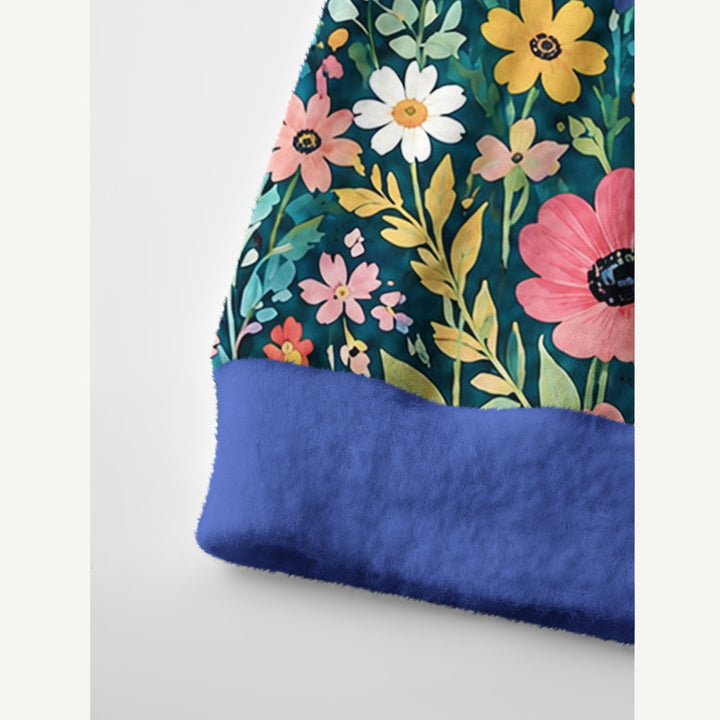 Cardigan lavorato a maglia color verde petrolio scuro con prato di fiori selvatici